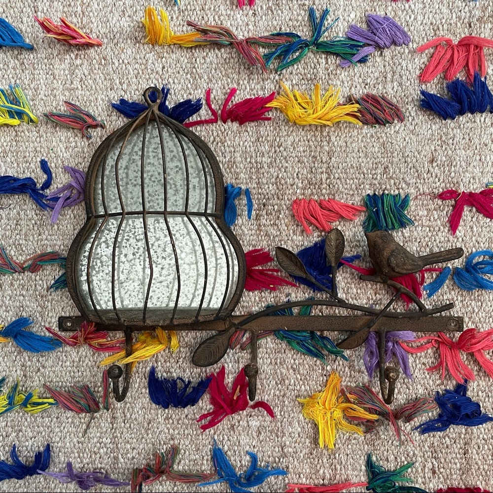 Rusted birdhouse and bird hook